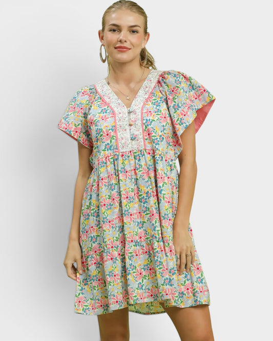 Woman wearing a floral dress against a white background