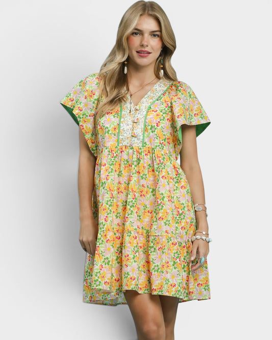 Woman wearing a floral dress on a plain background