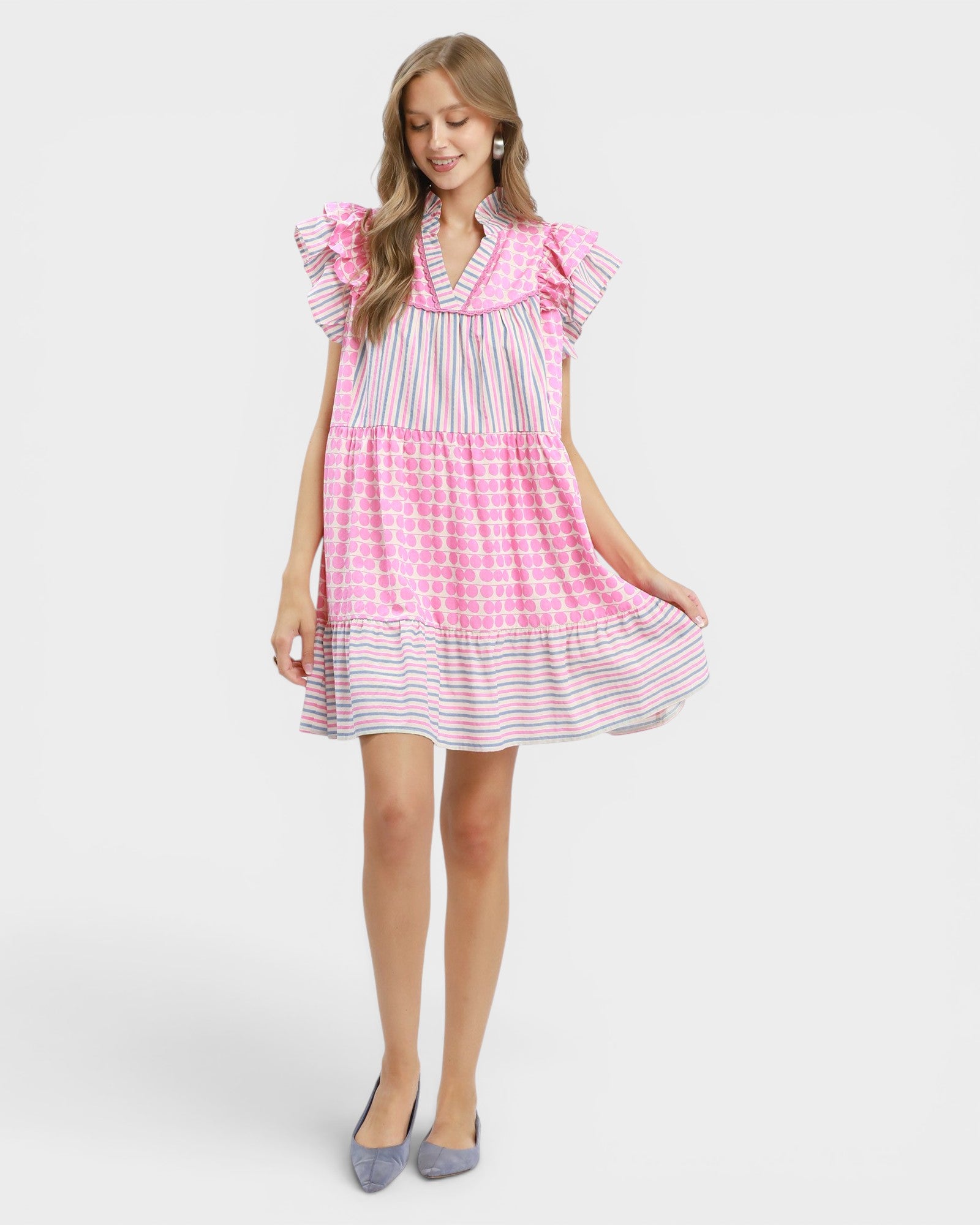 Woman wearing a pink and white checkered dress on a white background