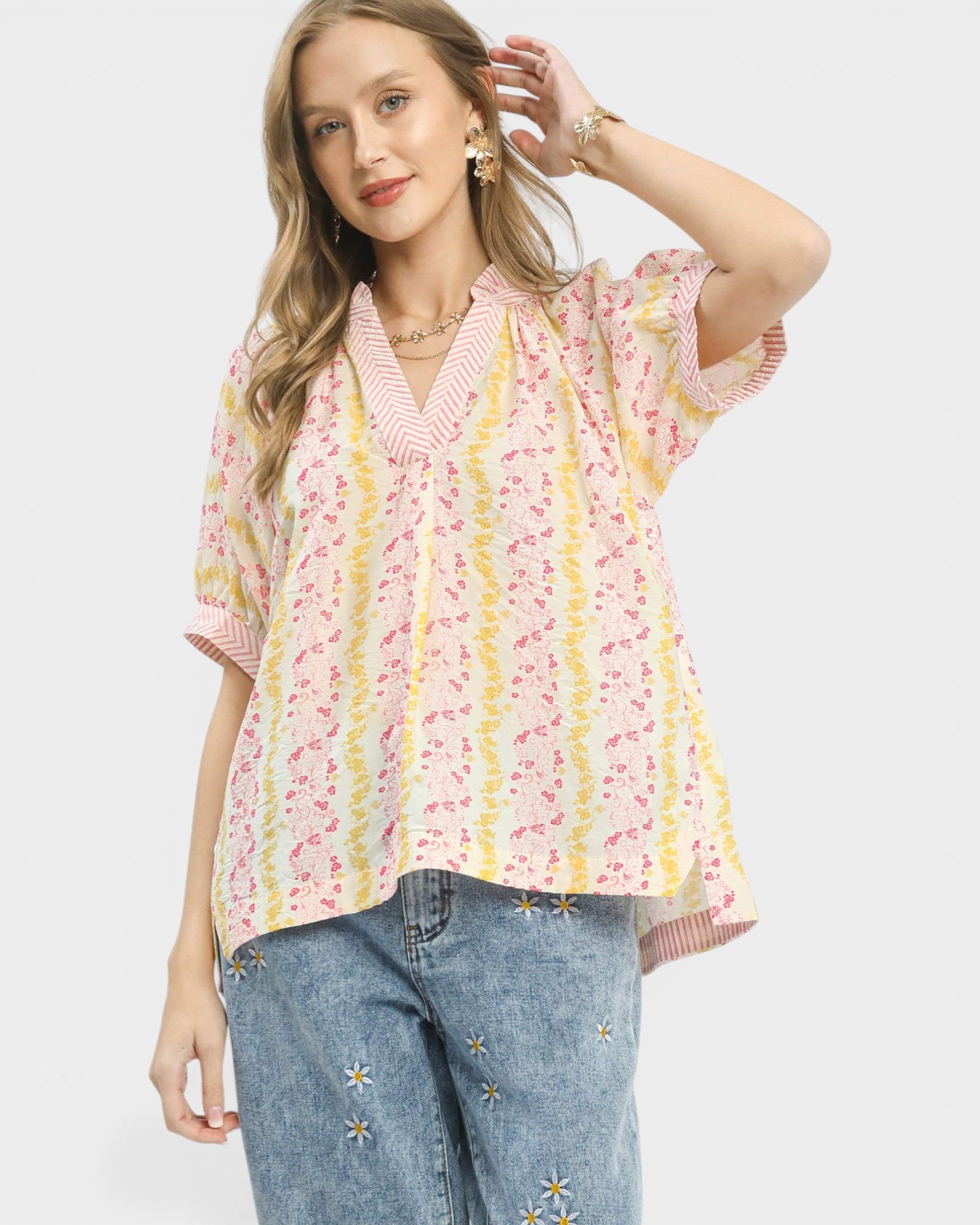 Woman wearing a floral blouse with a white background