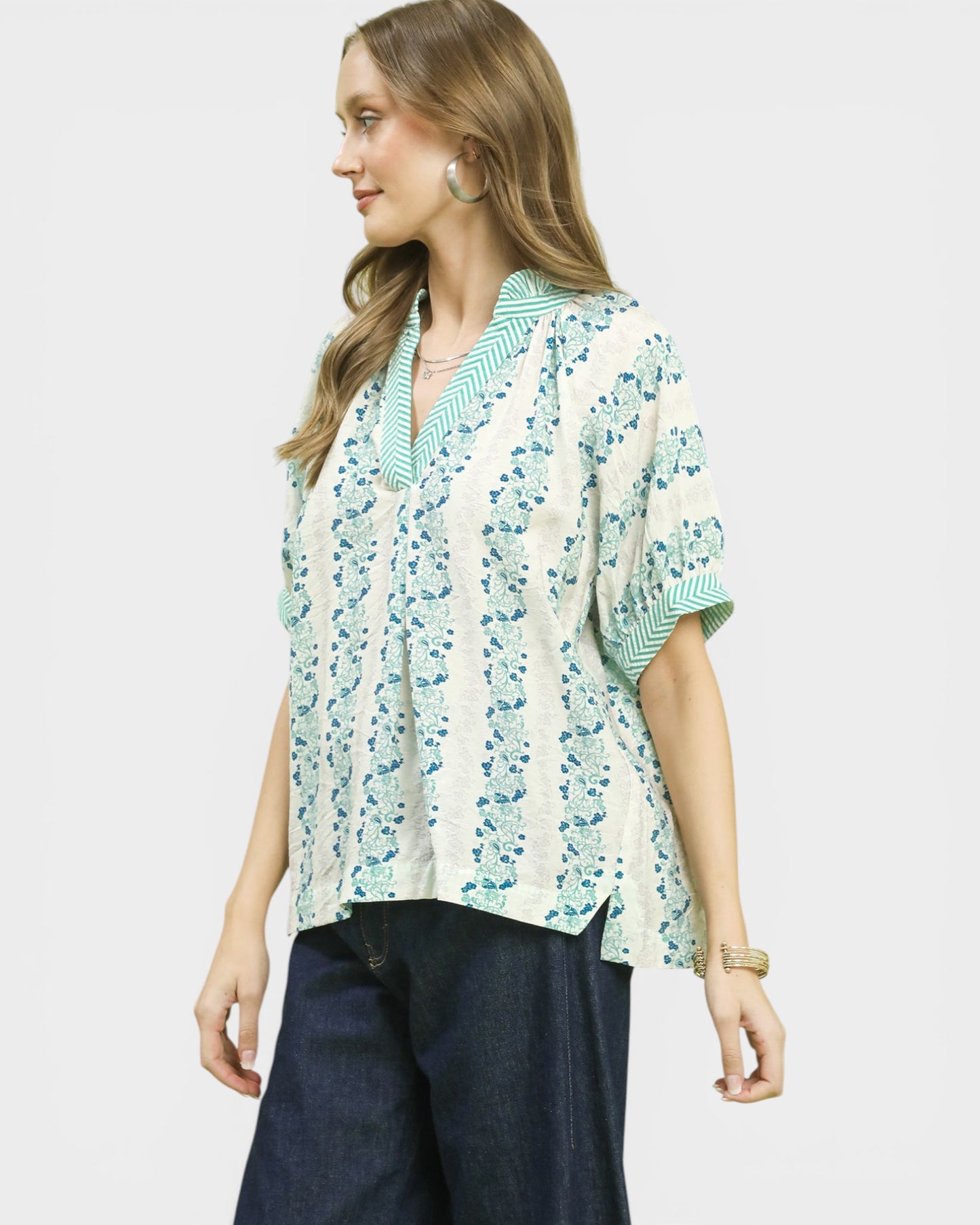 Woman wearing a floral blouse with a white background