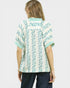Woman wearing a patterned shirt with a white background