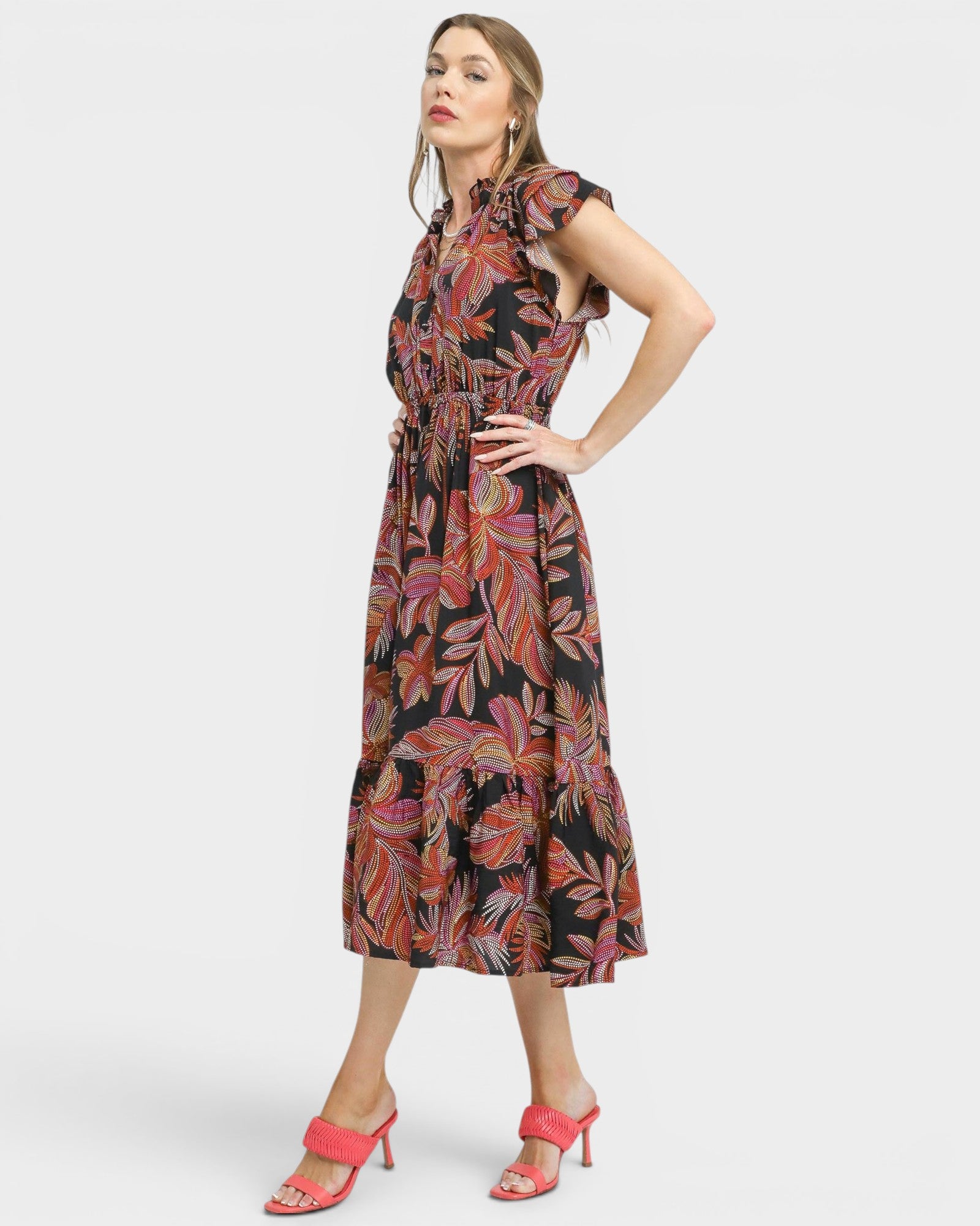 Woman wearing a patterned dress on a white background