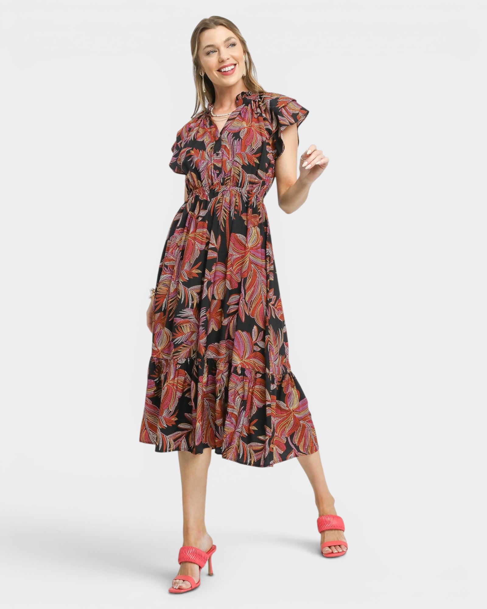 Woman wearing a patterned dress on a white background