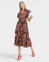 Woman wearing a patterned dress on a white background