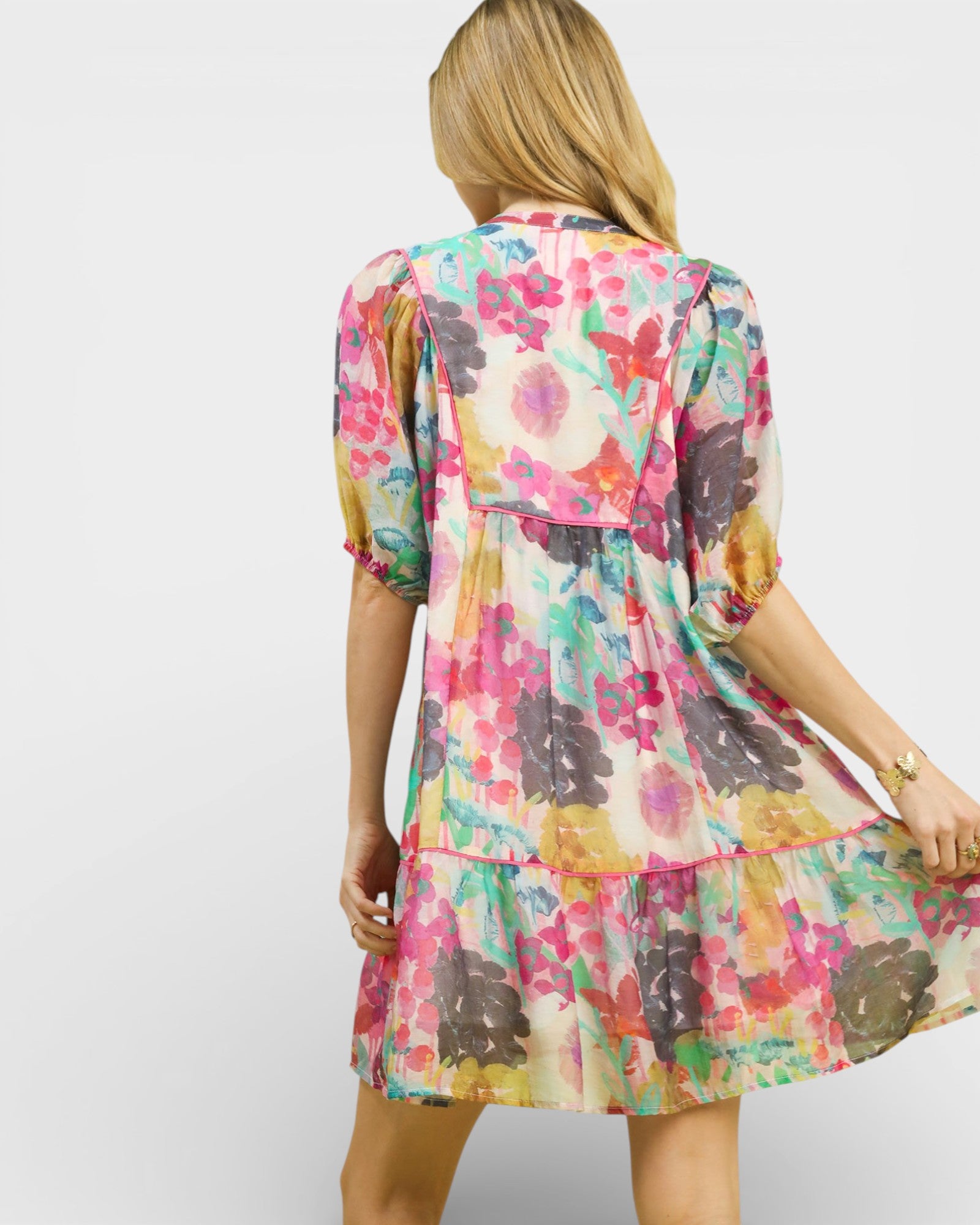 Woman wearing a colorful floral dress on a white background