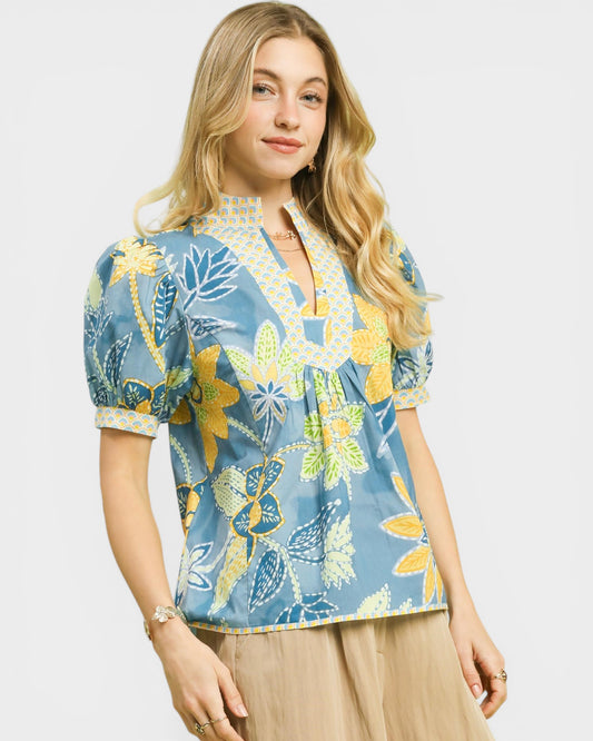 Woman wearing a floral blouse with a plain background