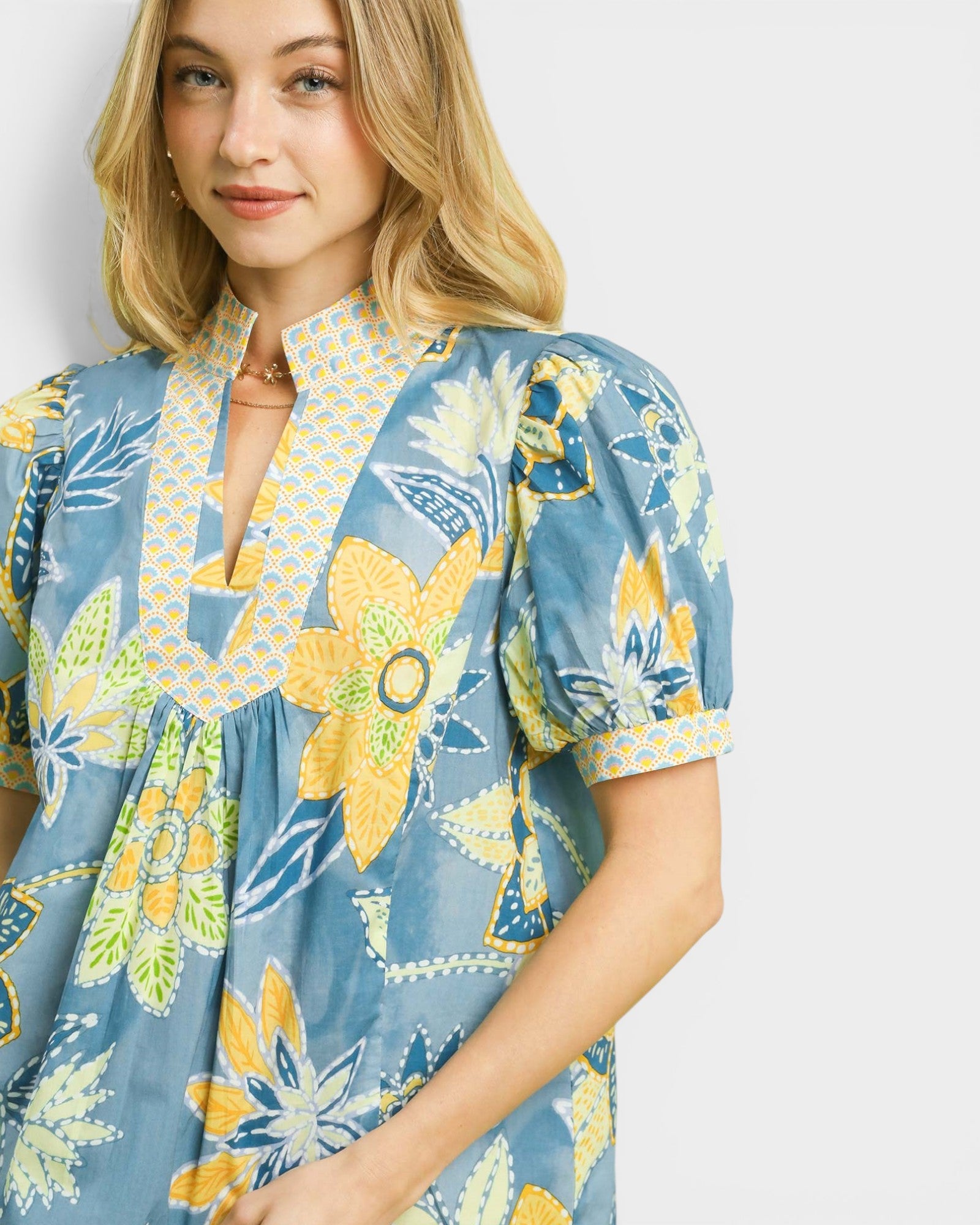 Woman wearing a floral dress with a blue background