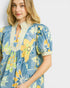 Woman wearing a floral dress with a blue background