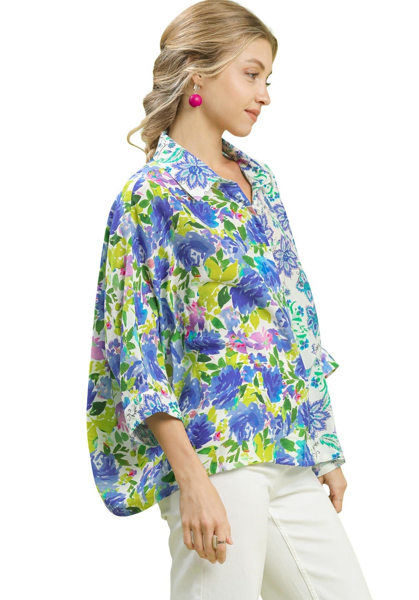 Woman wearing a colorful floral blouse on a white background