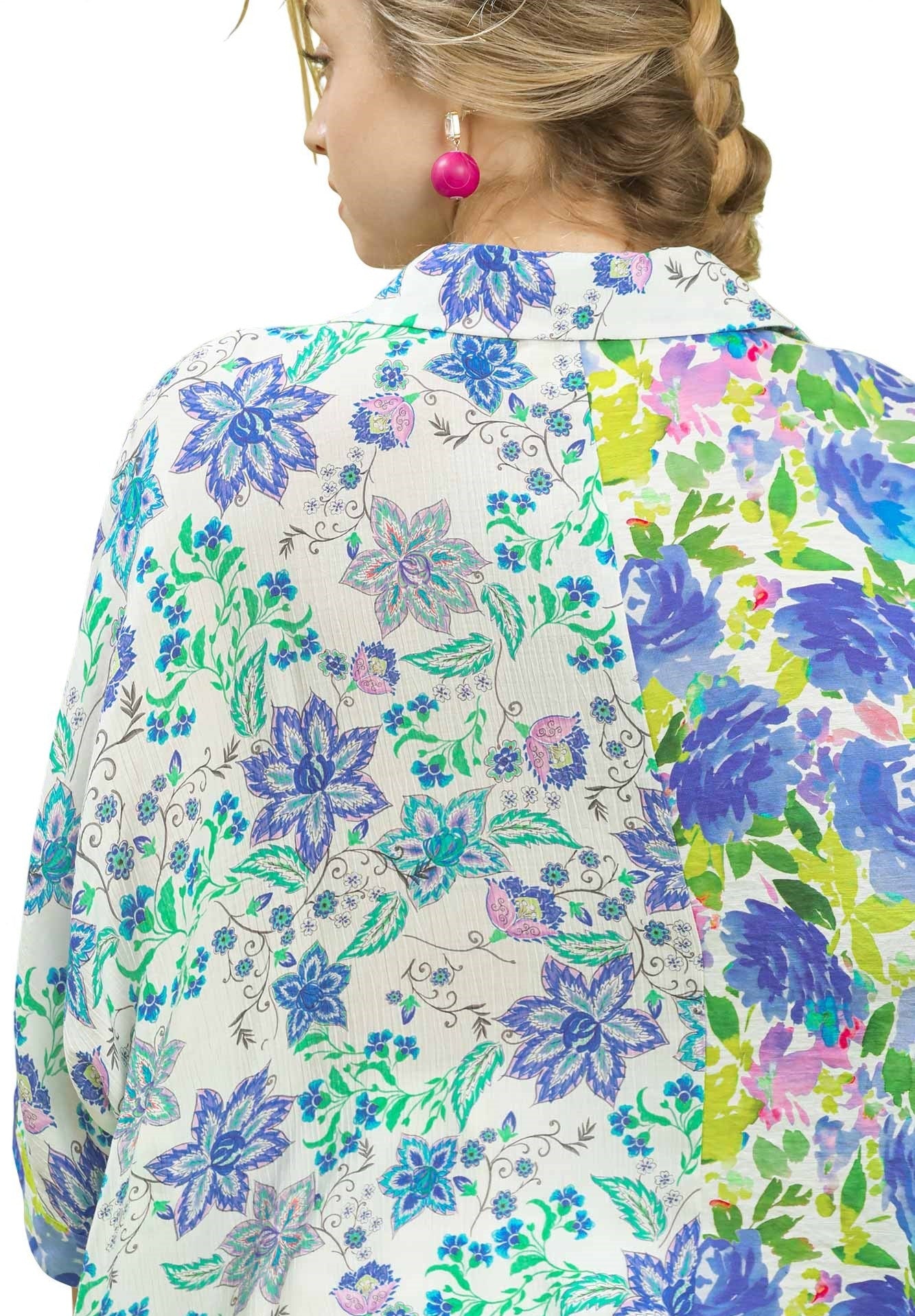 Person wearing a colorful floral patterned shirt with 'OCEAN' branding.