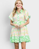 Woman wearing a colorful floral dress on a white background