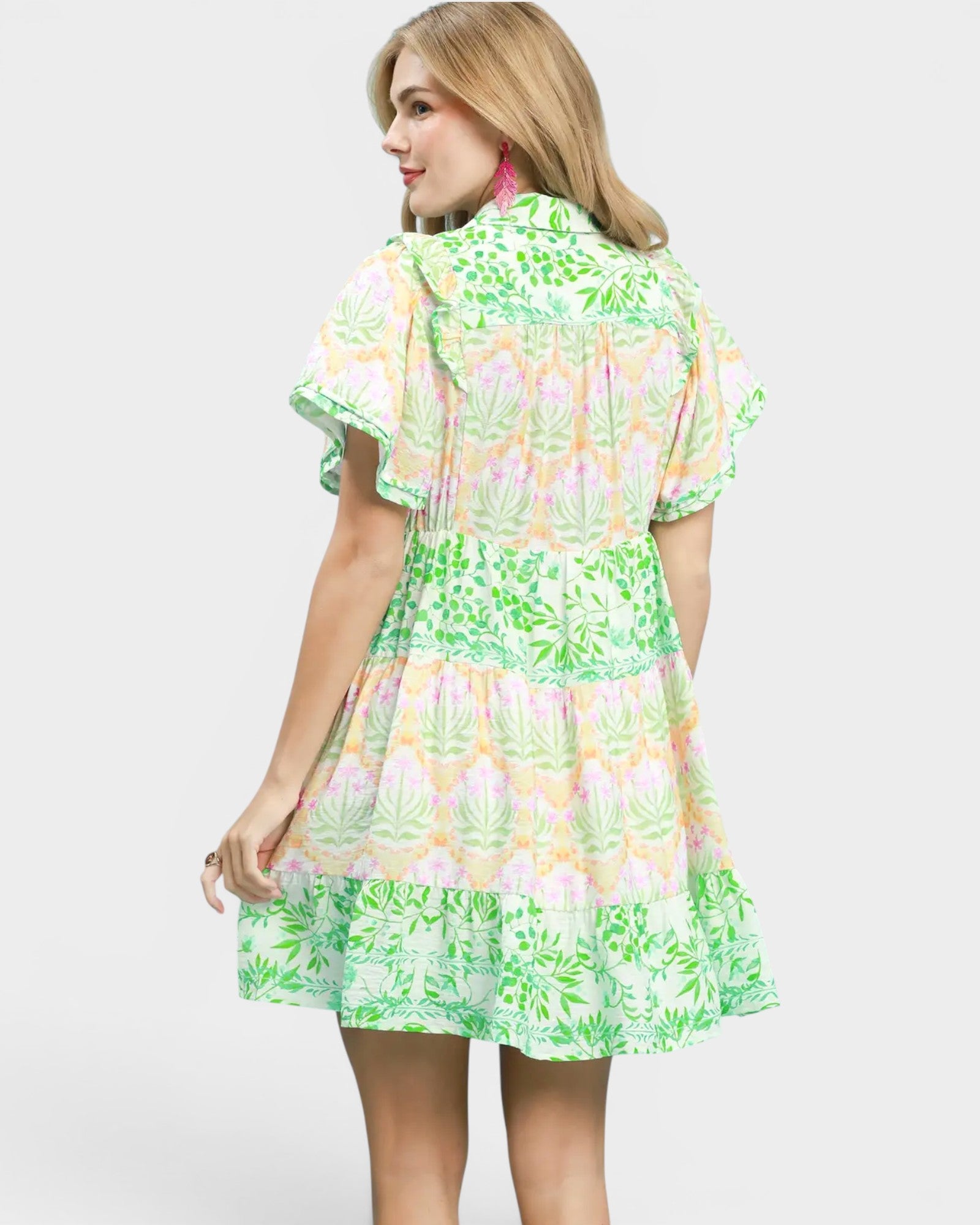 Woman wearing a colorful floral dress on a white background