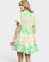 Woman wearing a colorful floral dress on a white background