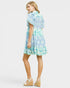 Woman wearing a floral dress on a plain background