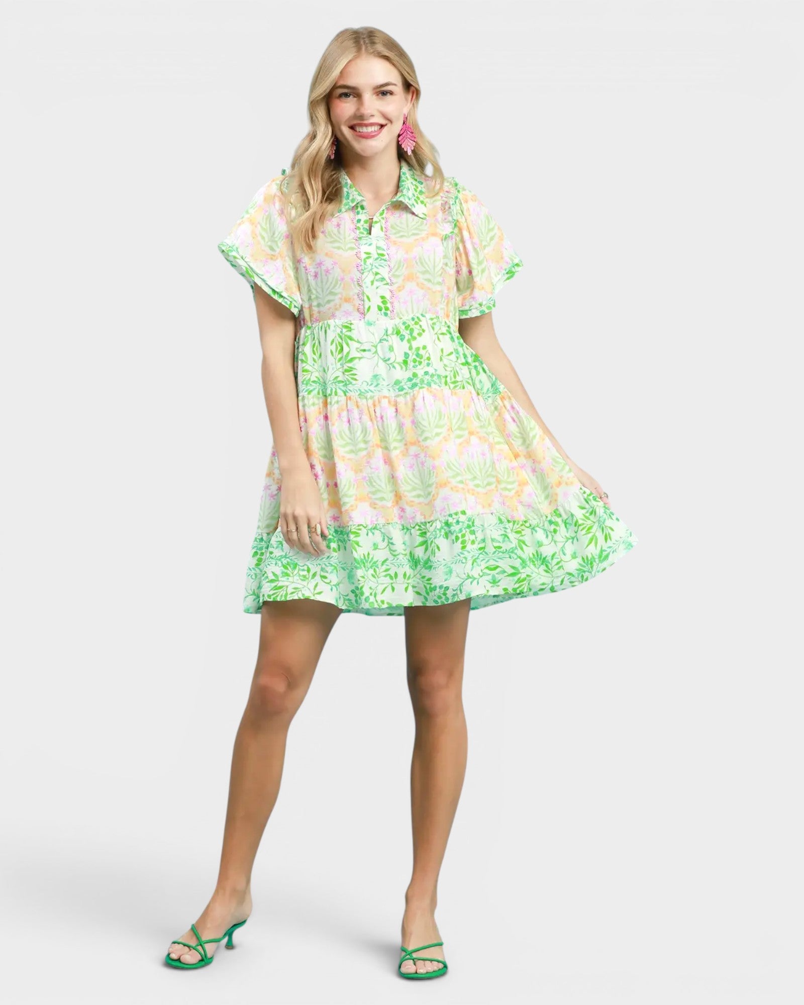 Woman wearing a colorful floral dress on a white background