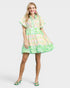 Woman wearing a colorful floral dress on a white background