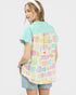 Person wearing a colorful patterned shirt over a green base shirt on a white background
