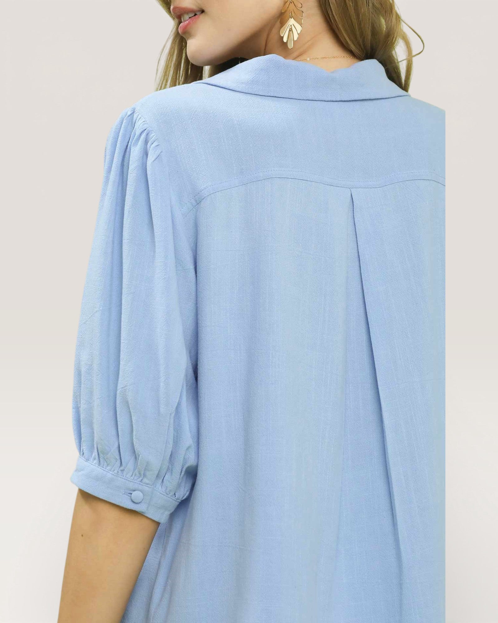 Light blue blouse worn by a person on a plain background