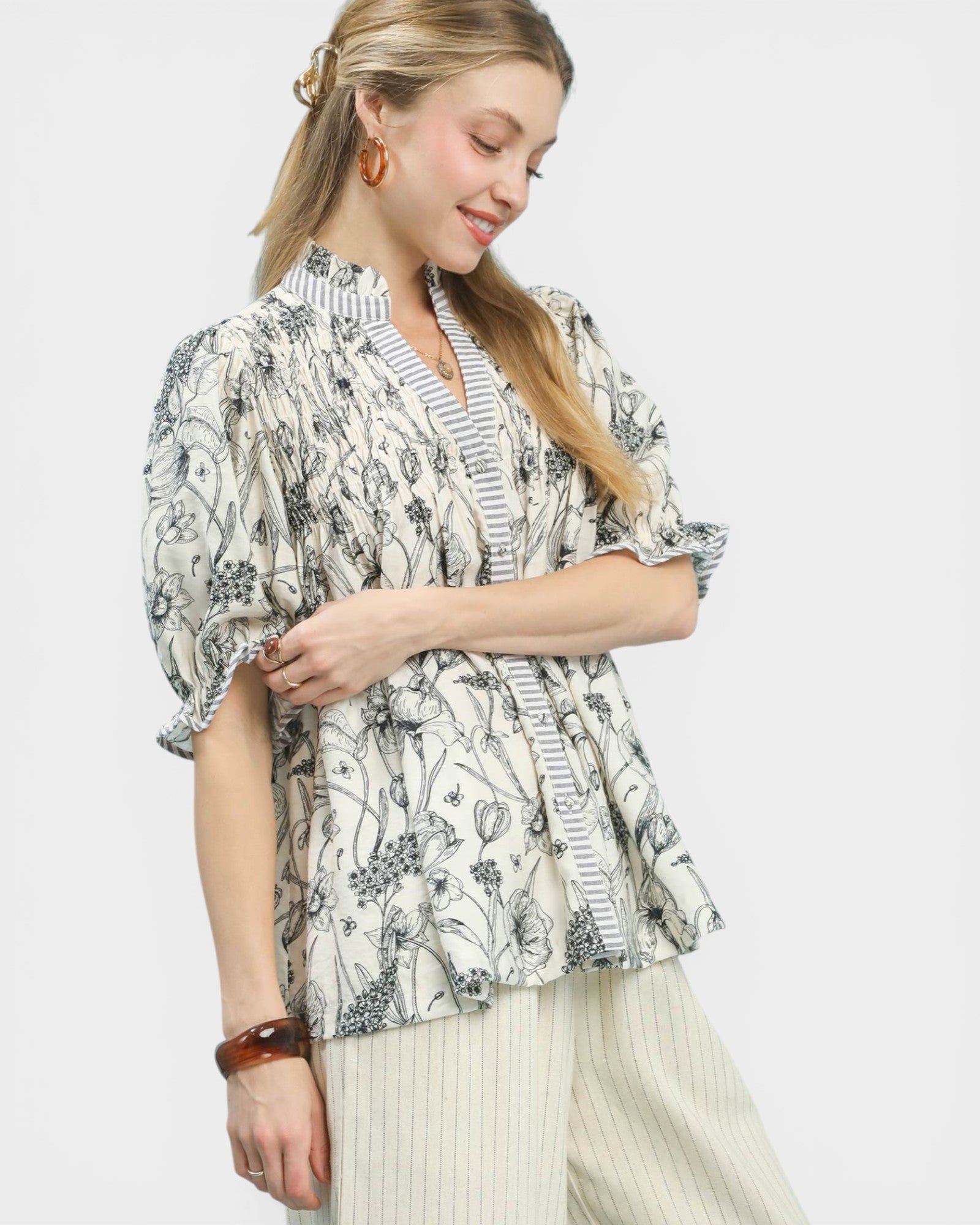 Woman wearing a floral blouse with a plain background
