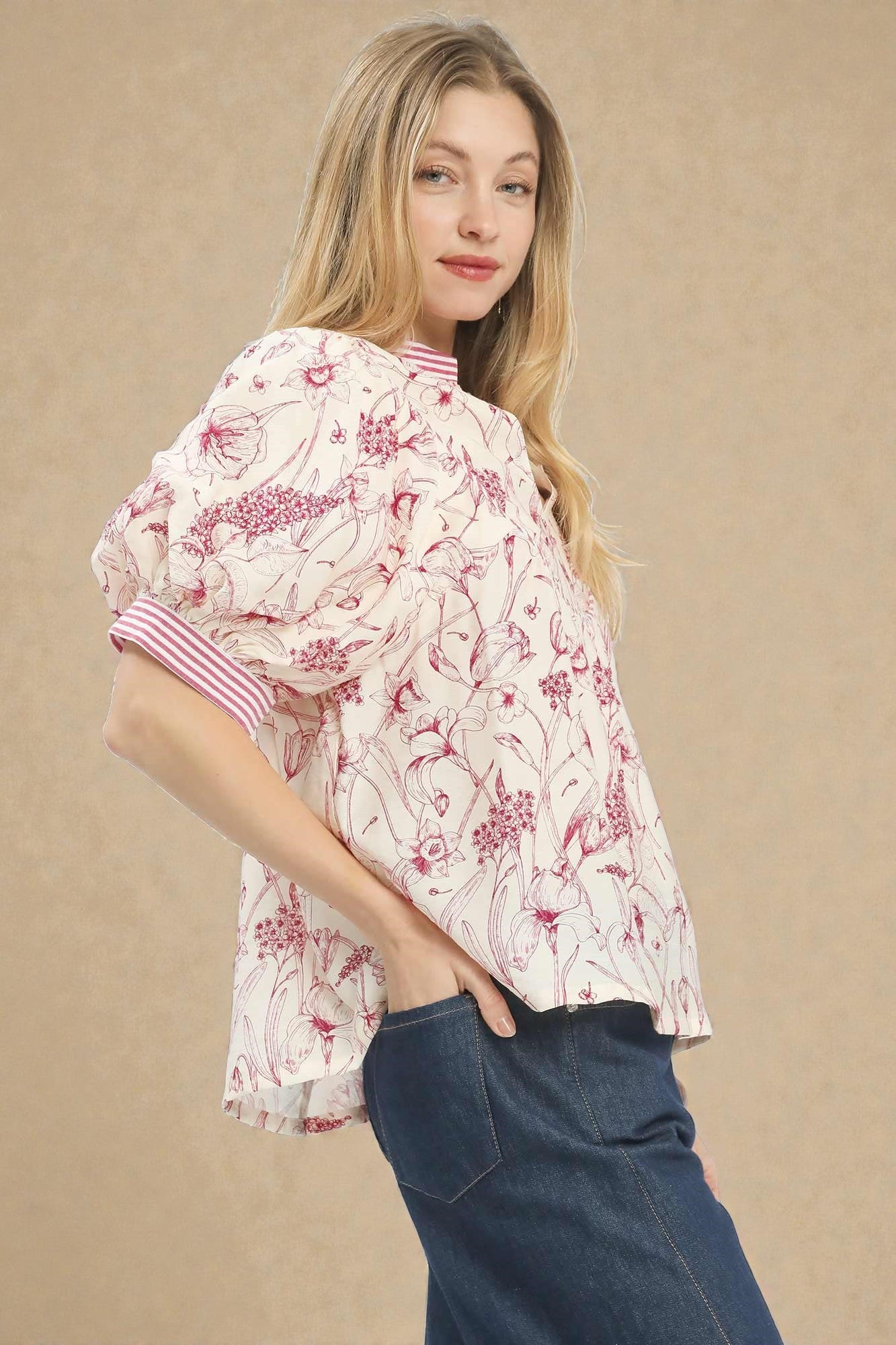 Woman wearing a floral blouse with a beige background