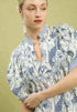 Woman wearing a floral dress with a beige background