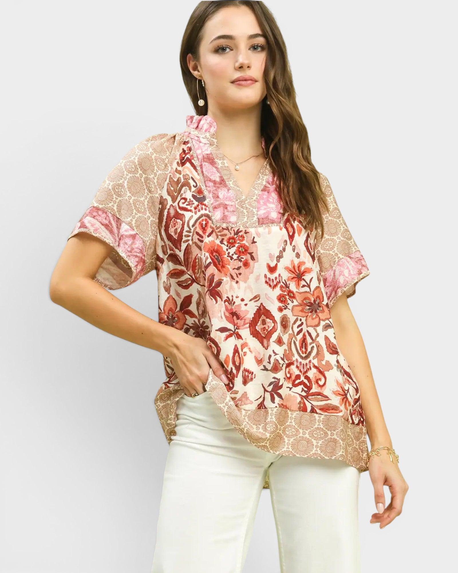 Woman wearing a floral blouse with a plain background