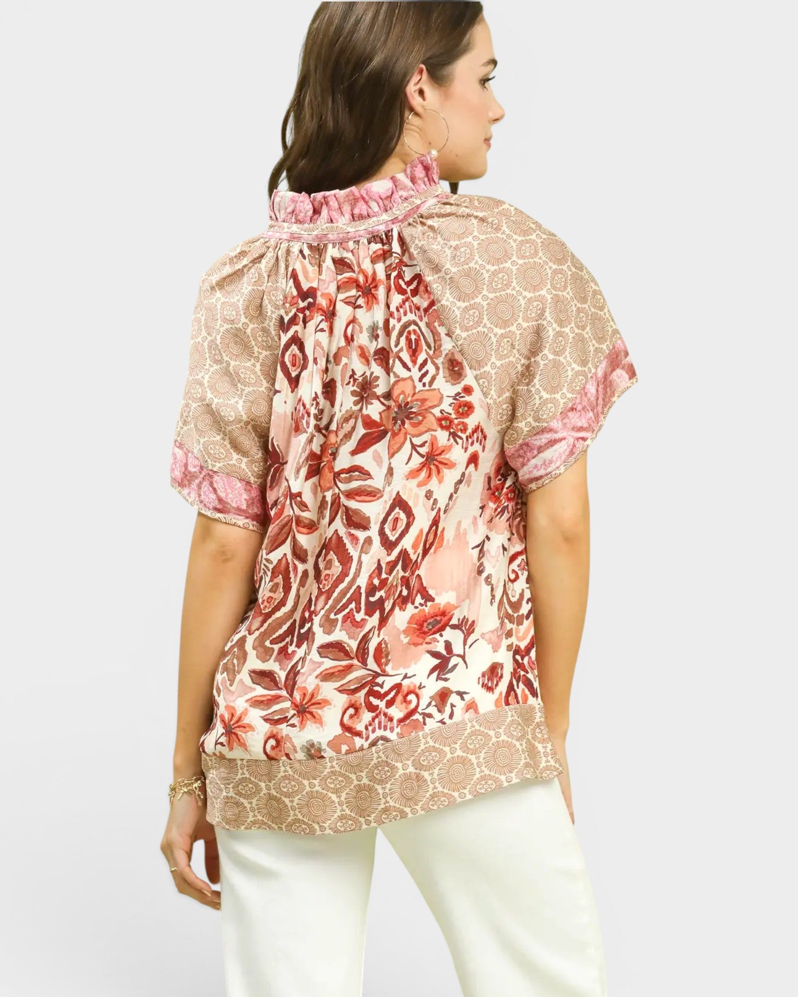 Woman wearing a floral blouse with a plain background