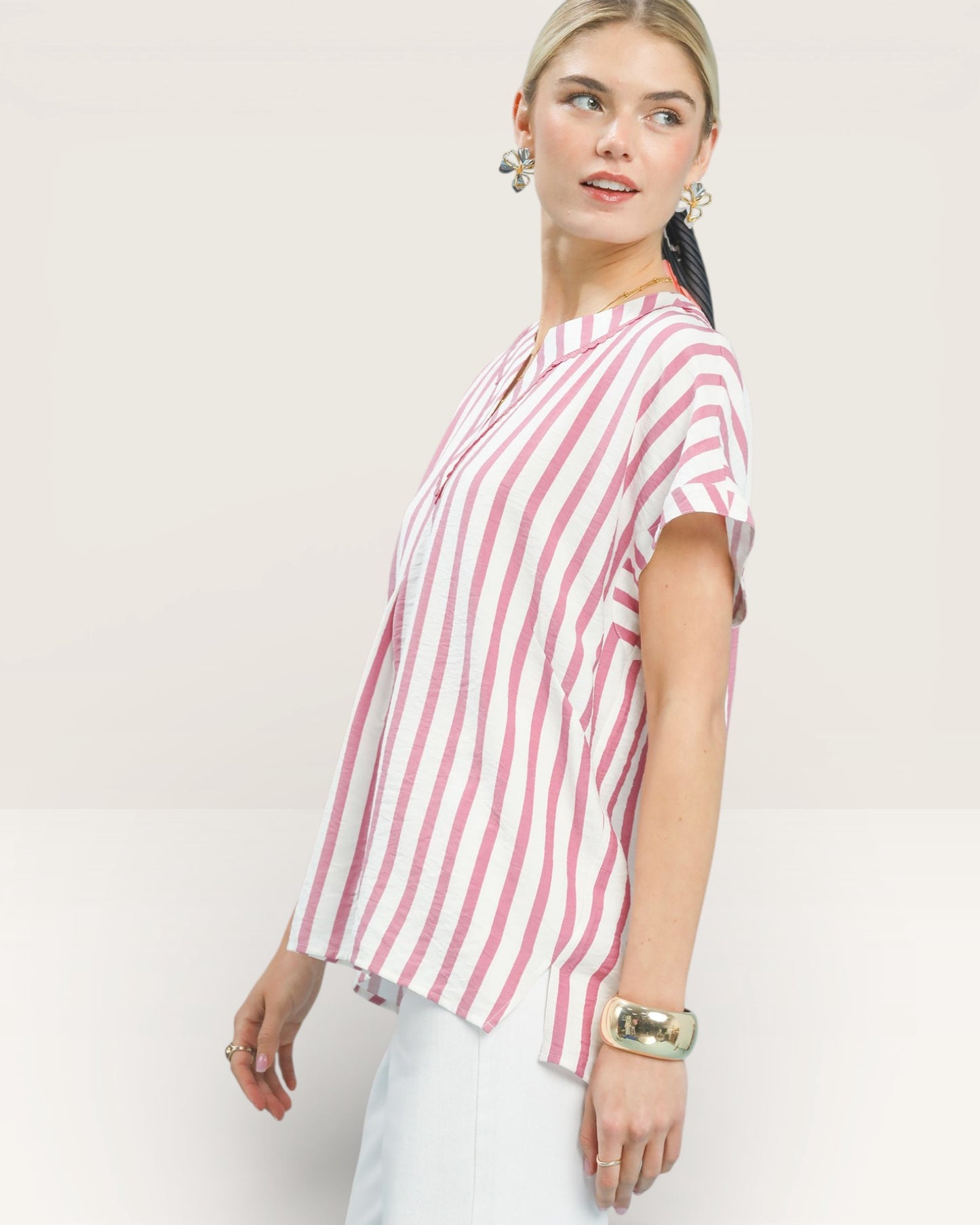 Woman wearing a red and white striped shirt on a plain background