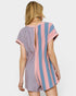 Woman wearing a pink and blue striped romper on a white background