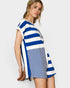 Woman wearing a blue and white striped romper with on a plain background