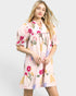 Woman wearing a floral dress on a plain background