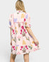 Woman wearing a floral dress on a white background