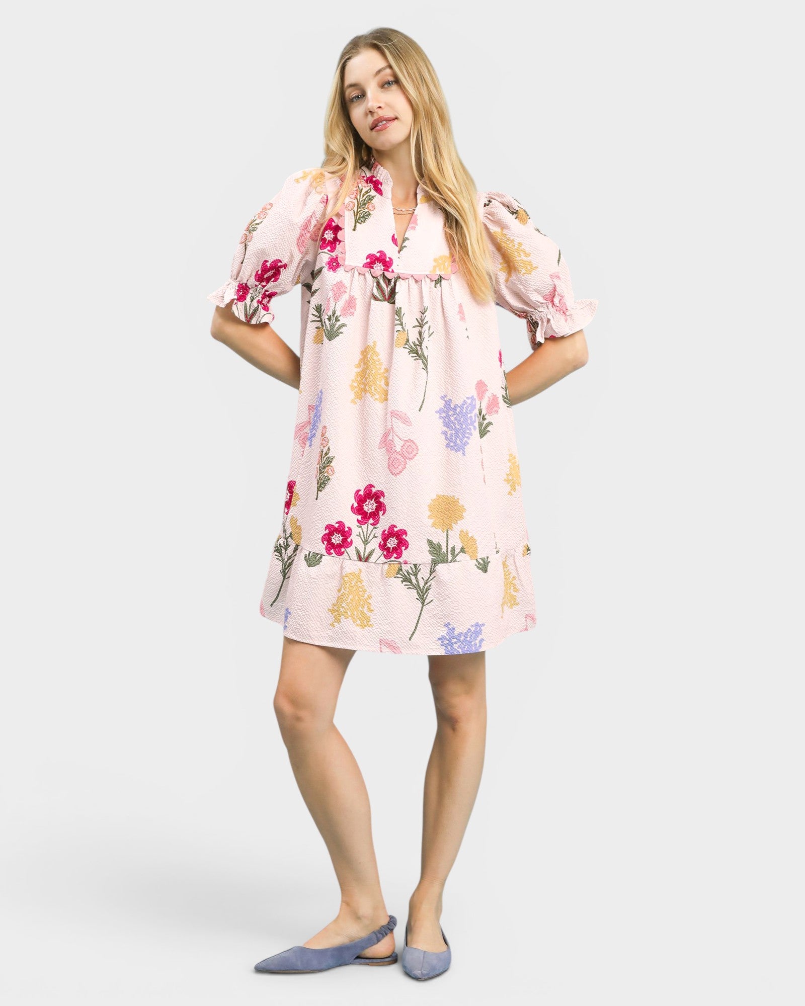 Woman wearing a floral dress on a white background