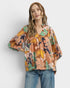 Woman wearing a floral blouse with a plain background