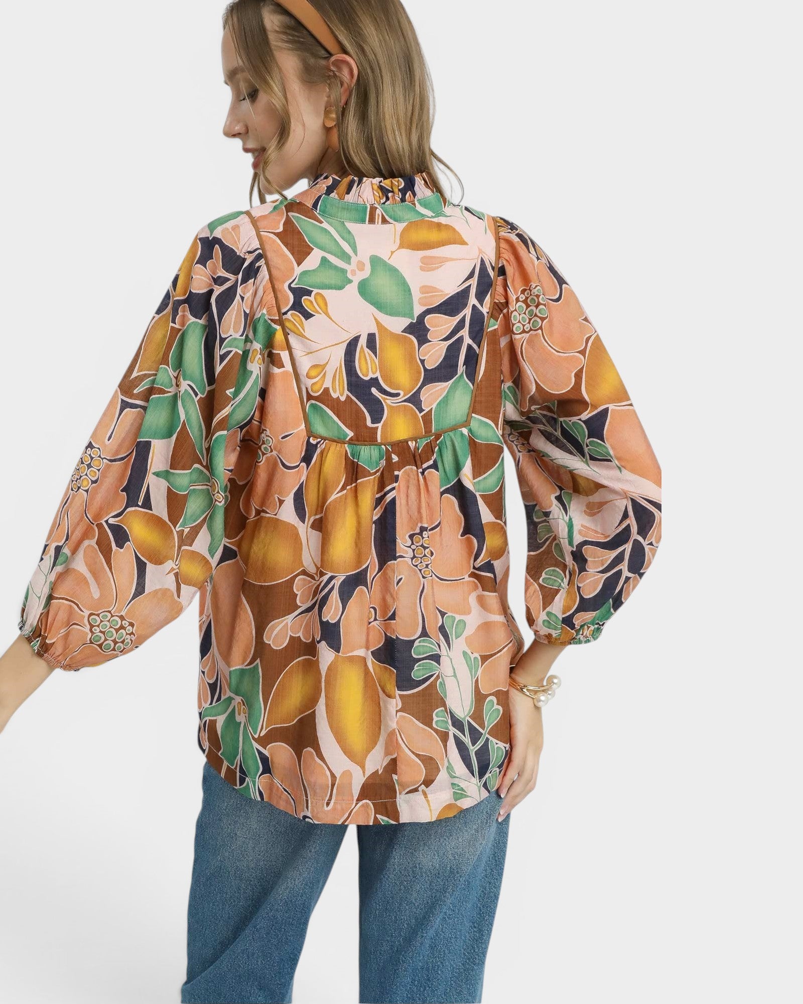 Woman wearing a floral blouse with a white background