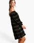 A woman modeling an off-the-shoulder black dress with a textured, shimmering gray plaid pattern, photographed against a clean white studio background.