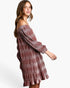 A woman modeling an off-the-shoulder long-sleeve dress with a textured, pleated pattern in dusty rose and brown tones, set against a plain white studio background.