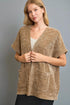 Woman wearing a brown textured cardigan against a gray background