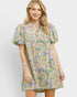 Woman wearing a colorful floral dress on a white background