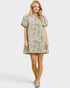 Woman wearing a colorful patterned dress on a white background