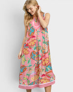 Woman wearing a colorful floral dress on a white background
