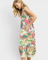 Woman wearing a colorful floral dress on a white background