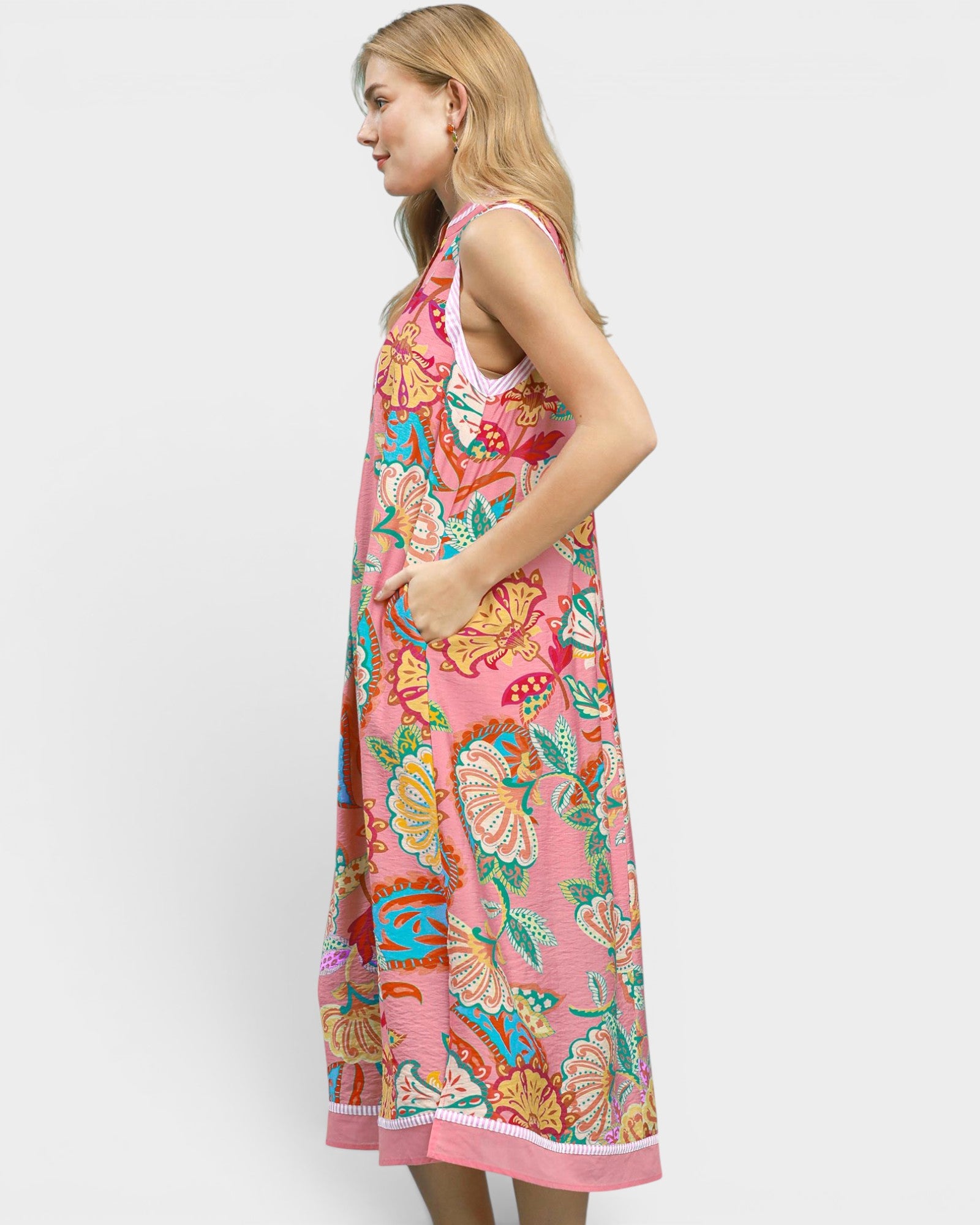 Woman wearing a colorful floral dress on a white background