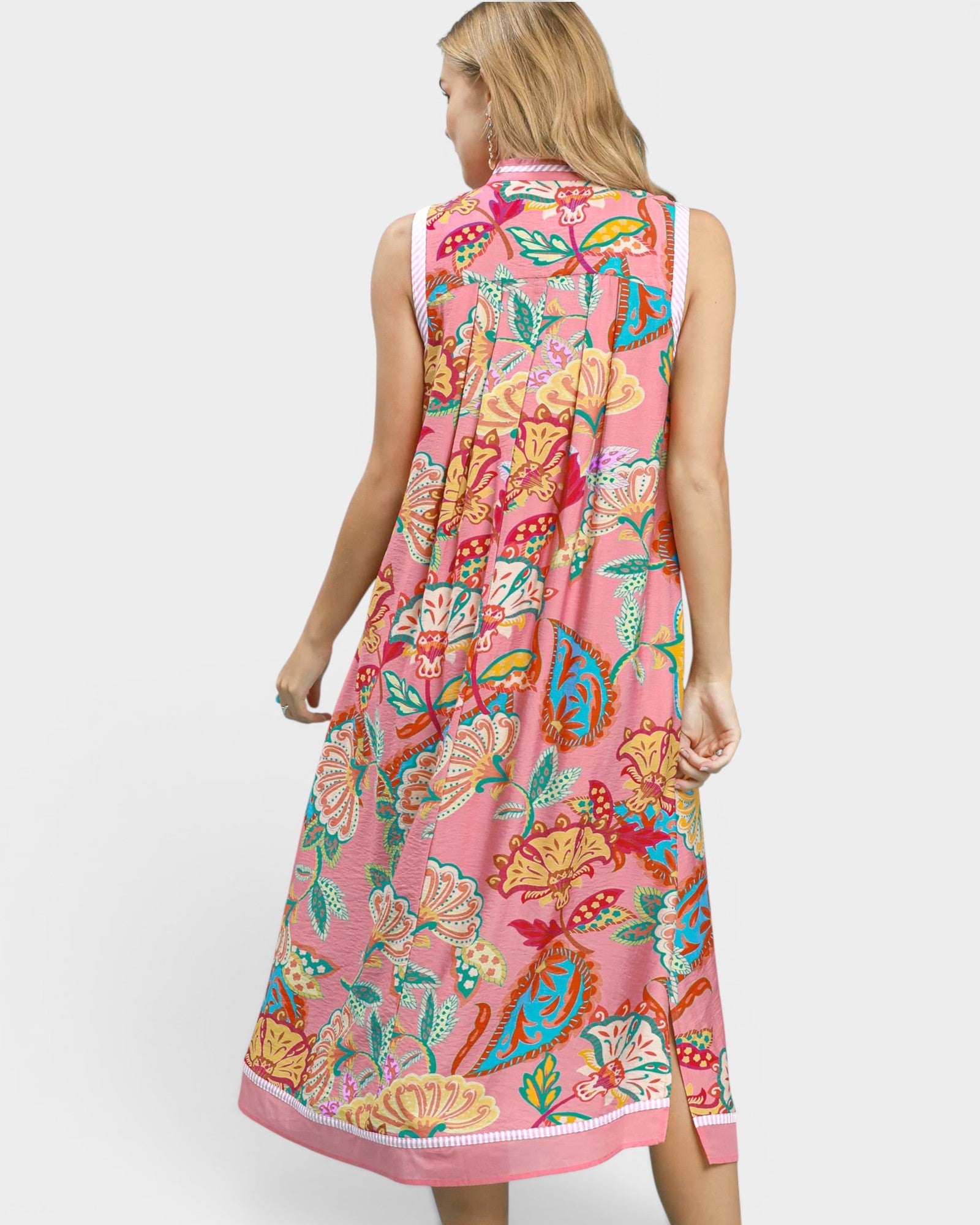 Woman wearing a pink floral dress on a white background