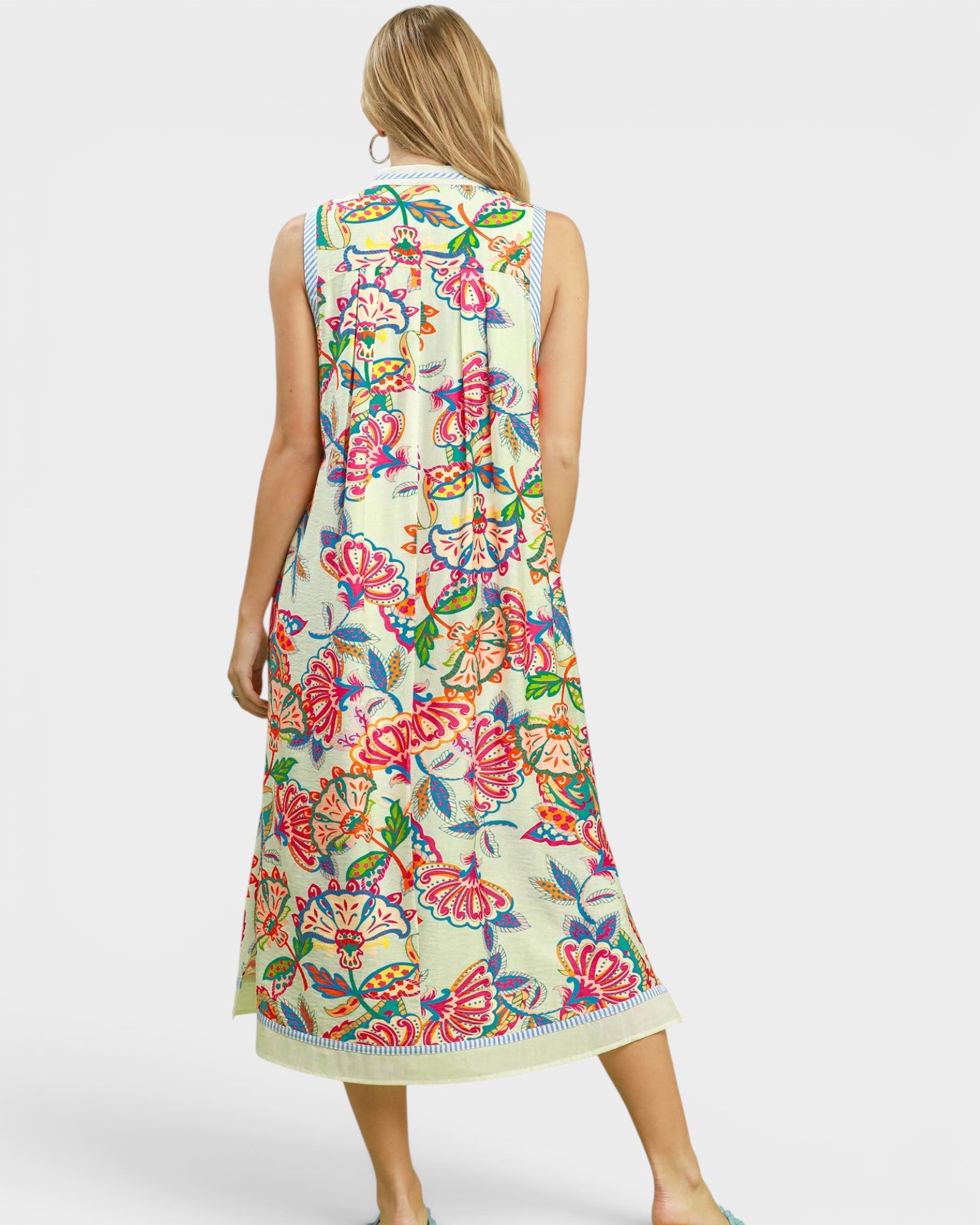 Woman wearing a colorful floral dress on a white background