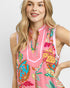 Woman wearing a colorful sleeveless dress with a white background