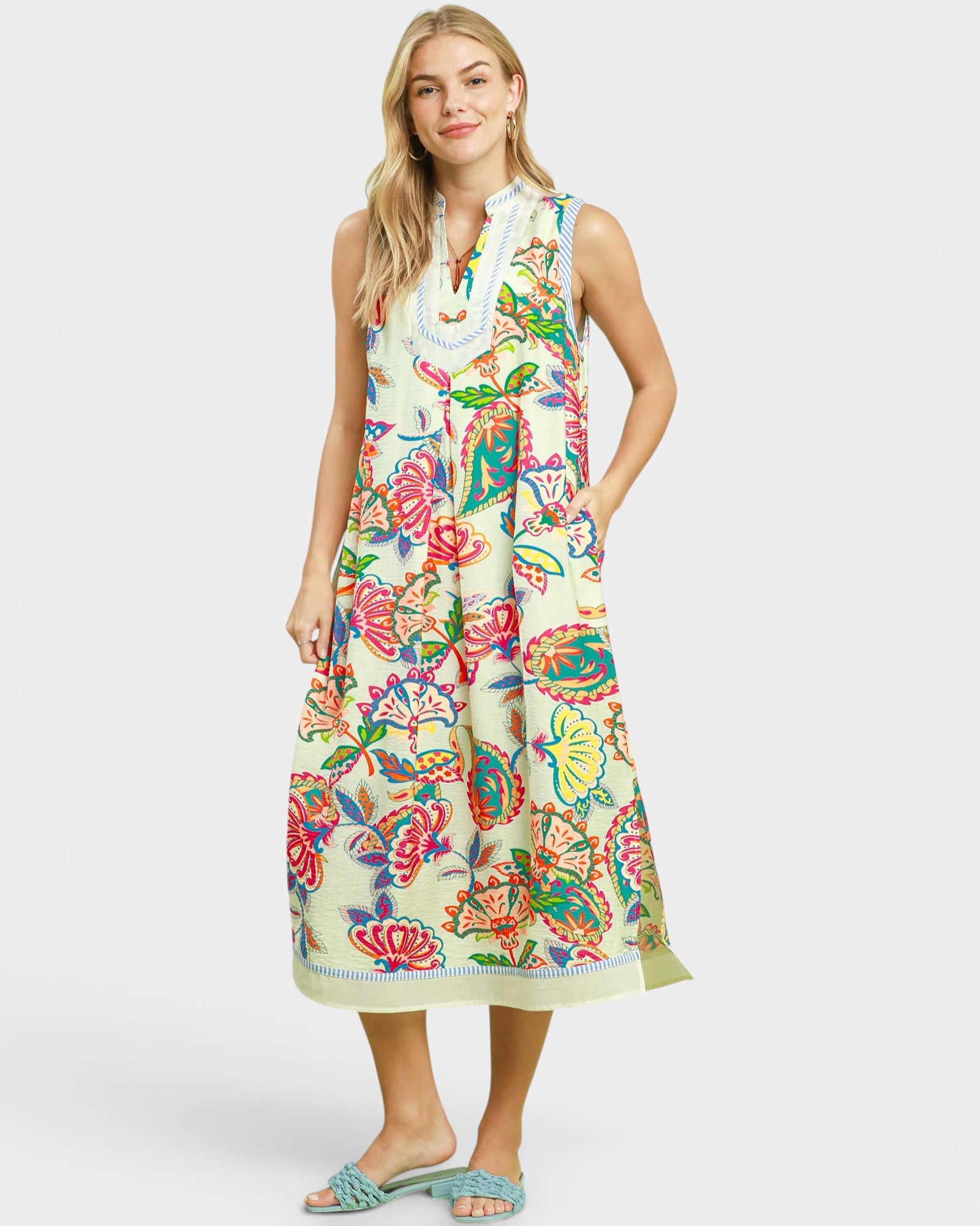 Woman wearing a colorful floral dress on a white background