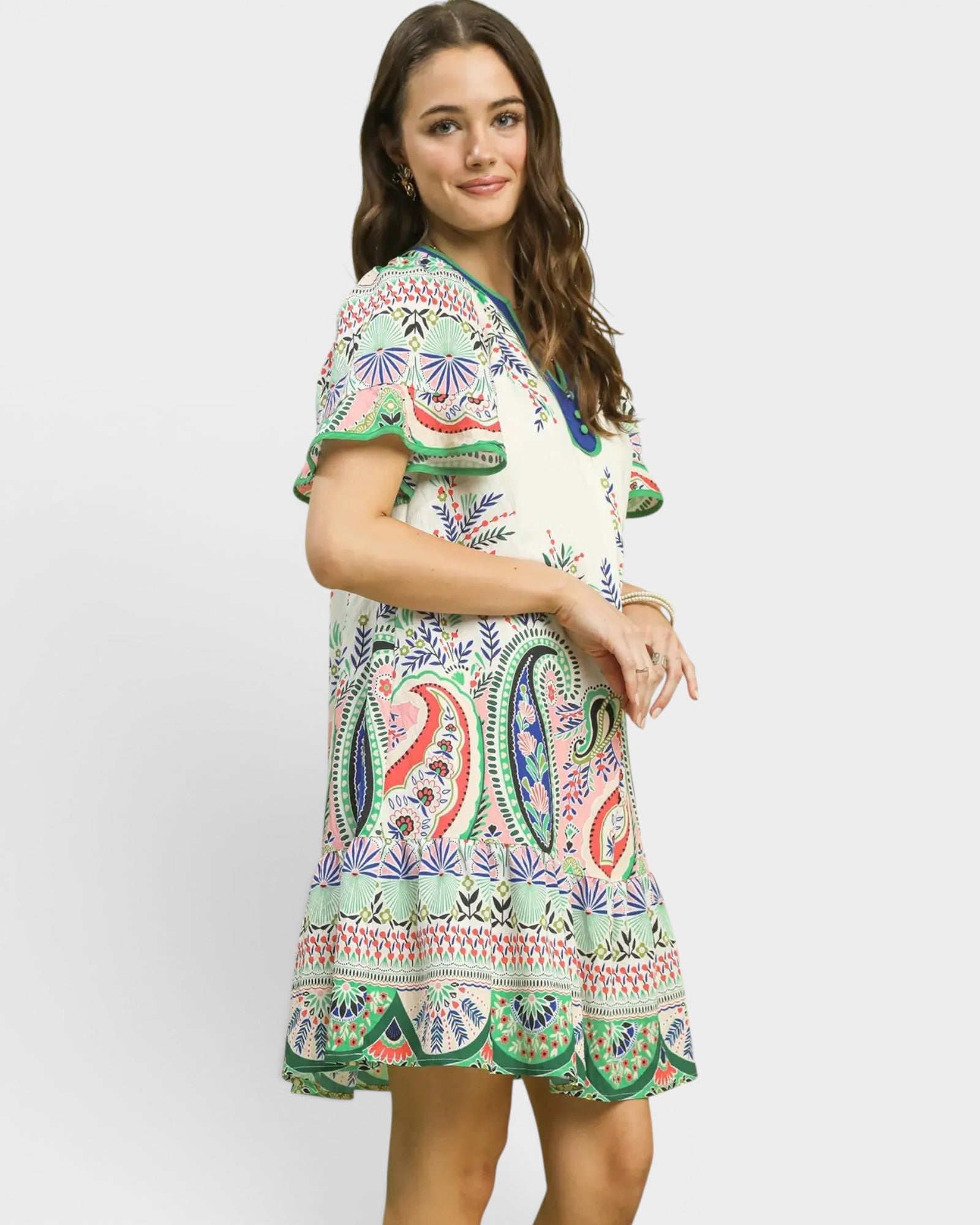Woman wearing a colorful patterned dress on a white background