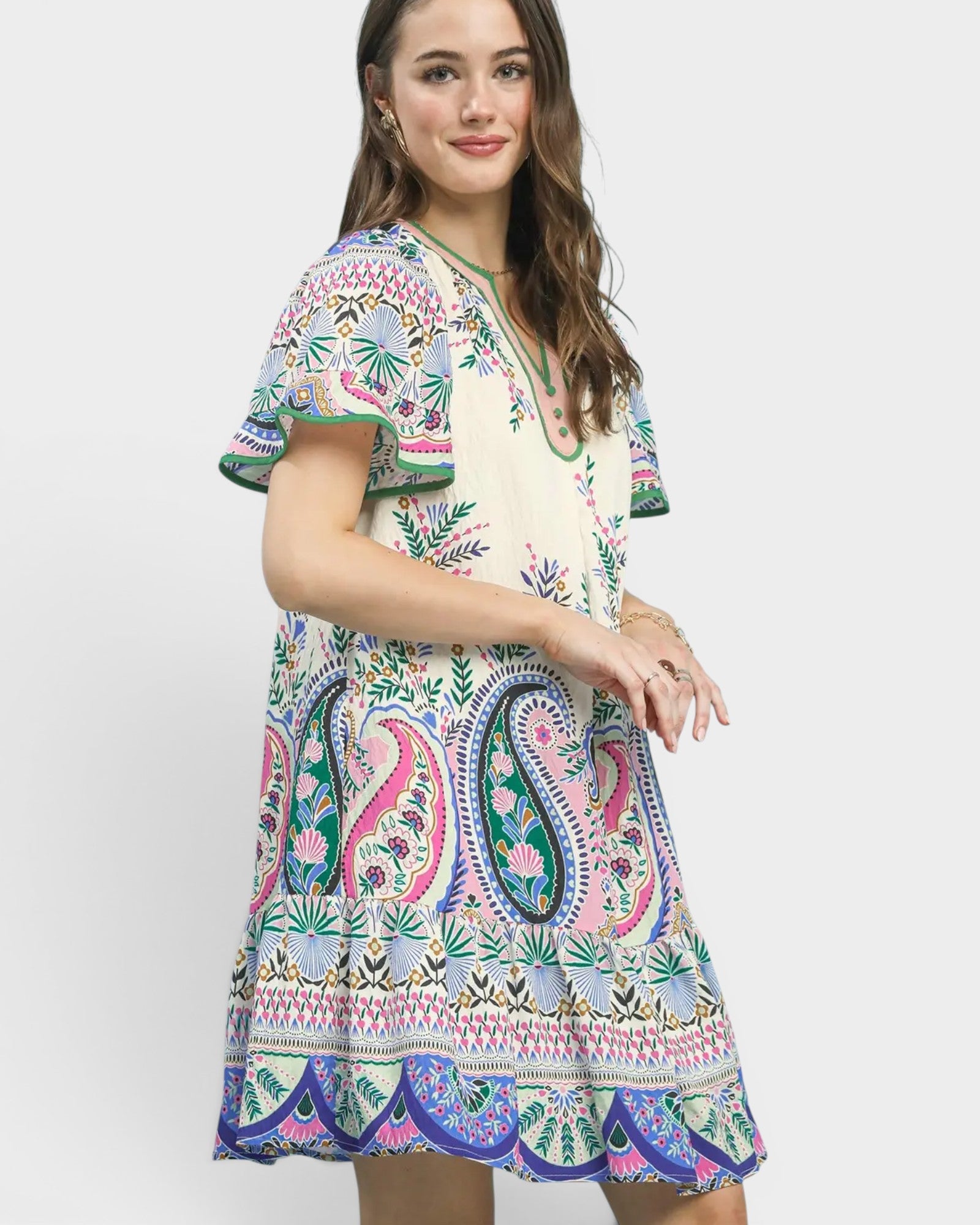 Woman wearing a colorful patterned dress on a white background